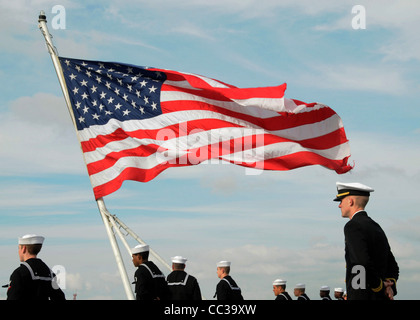 Sailors assigned to the Nimitz-class aircraft carrier USS Abraham Lincoln (CVN 72) man the rails while departing San Diego. Stock Photo