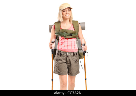 A smiling woman with backpack and hiking poles posing Stock Photo