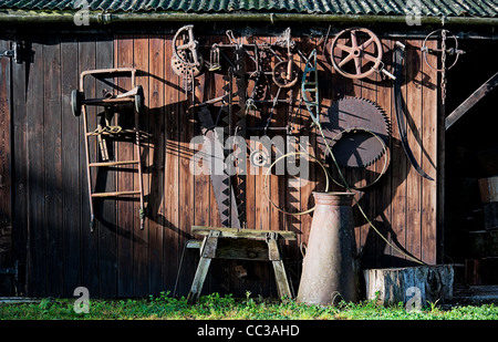 Wooden shed with rusty old tools in side lighting Stock Photo