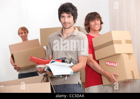 House mates carrying boxes Stock Photo