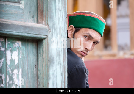Kinnaur man from the mountainous region in Himachal Pradesh of north India looking at camera wearing the cap typical of the Kinnauri Peoples Stock Photo