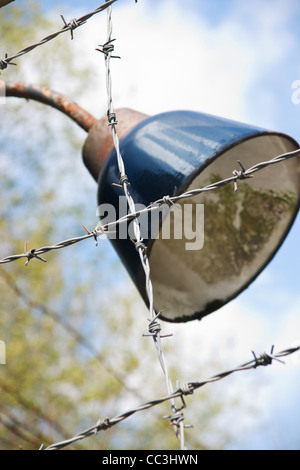 Barb wire fence with lamp in former German Nazi concentration and ...