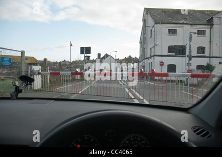 Train Railway Level Crossing With The Barriers Down As Seen Through A Car Windscreen Stock Photo