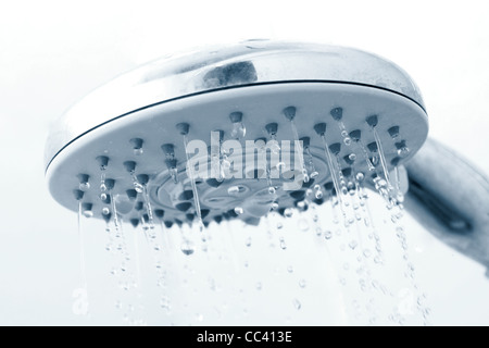 A shower head with running water Stock Photo