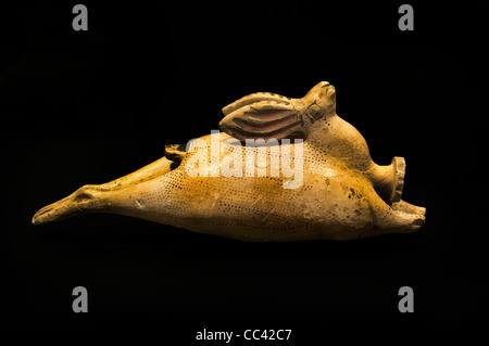 An ancient Etruscan-Corinthian ceramic perfume bottle in the form of a reclining hare, dating from circa 540 BC, isolated against a solid black background Stock Photo