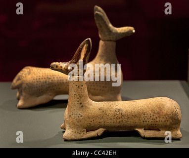 An ancient Etruscan-Corinthian ceramic perfume bottle in the form of a reclining hare, dating from circa 540 BC, isolated against a solid black background Stock Photo