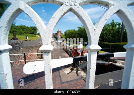 Narrow boat passing through Bratch Locks on Staffordshire and Worcester Canal at Wombourne Staffordshire UK Stock Photo