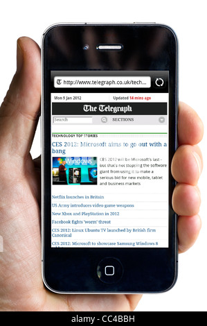 Reading the Daily Telegraph online newspaper on an Apple iPhone 4 Stock Photo