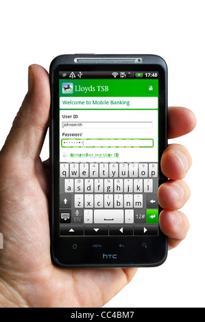 Logging on to mobile banking with the Lloyds TSB app on an HTC smartphone Stock Photo