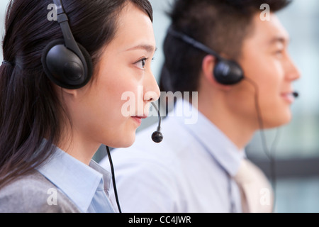 Side view of call center agents with headsets Stock Photo