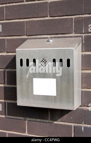 Outdoor Smokers Cigarette Bin Ashtray on Brick Wall Stock Photo