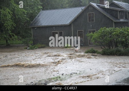 A flood victim makes his way toward his house after flood waters tropical storm Irene. caused him to evacuate in Fayston, VT Stock Photo