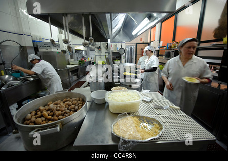 Chefs preparing food in restaurant's modern professional kitchen Stock Photo