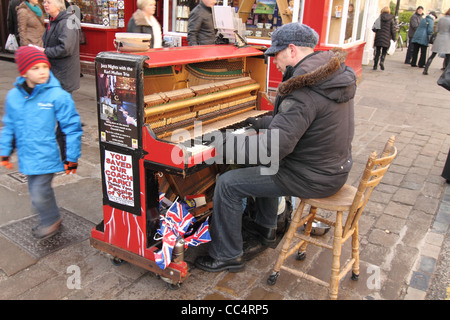 busker playing piano in street York UK Stock Photo