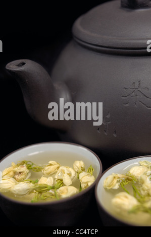 chinese jasmine tea pot and cups over black Stock Photo