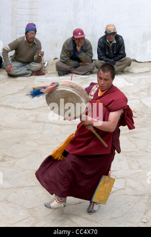 Drumming monk in the courtyard of Korzok Gompa, Korzok Gustor festival, Lake Tsomoriri, (Ladakh) Jammu & Kashmir, India Stock Photo