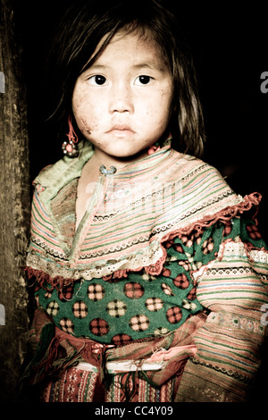 Portrait of a little girl from the Flower Hmong hill tribe at a village near Bac Ha, Northern Vietnam, South East Asia. Stock Photo