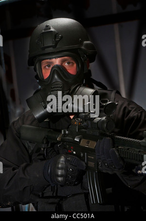 An airsoft player wearing special black forces uniform used in counter terrorist games (Posed by model) Stock Photo