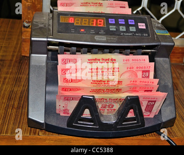 Digital equipment which is used to count the currency,here it shows counting 20 rupees indian notes Stock Photo