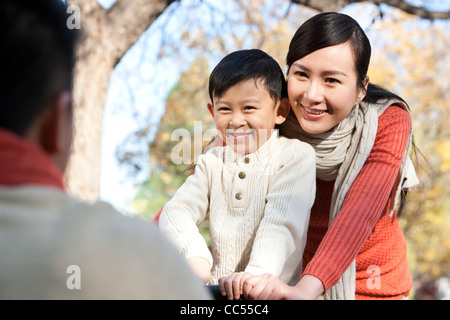 Boy on a bike with his mother Stock Photo