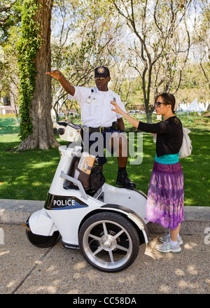 Female Police Officer Giving Directions To An Elderly Group Of People ...