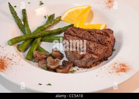 Filet Migon steak with sauted mushrooms and asparagus spears Stock Photo