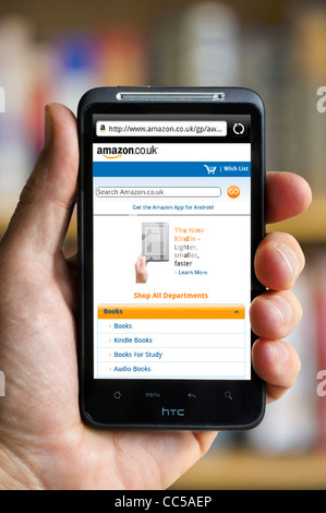Shopping online at the amazon.co.uk website on an HTC smartphone Stock Photo