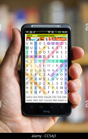 Playing Word Search on an HTC smartphone Stock Photo