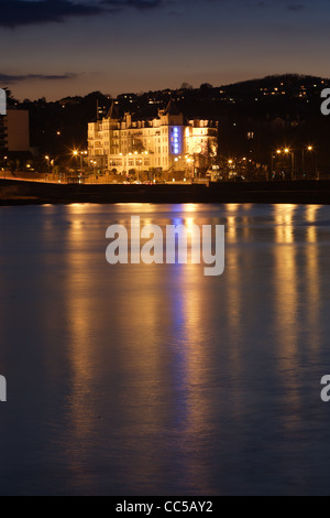 Evening scens of the Grand hotel in Torquay, Devon Reflecting in the calm water Stock Photo