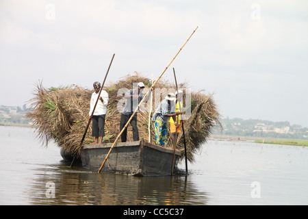 Farmers poling boat on Lac Nokoue near Ganvie stilt village, Benin, West Africa Stock Photo