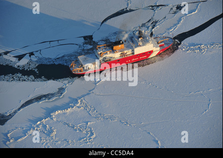 The 420-foot Coast Guard Cutter Healy breaks ice in the Bering Sea to assist the tanker Renda get to fuel starved Nome, Alaska January 8, 2012 in the Bering Sea. The Seattle-based cutter Healy is the Coast Guard’s newest and most technologically advanced polar icebreaker and is currently the United Stock Photo