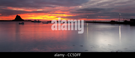 Panoramic landscape view of Lindisfarne Castle and harbour just before sunrise. Stock Photo