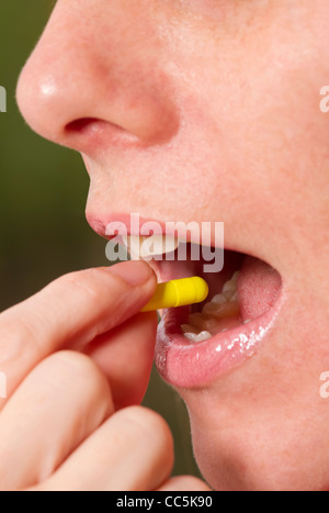 Woman taking tablet. Stock Photo