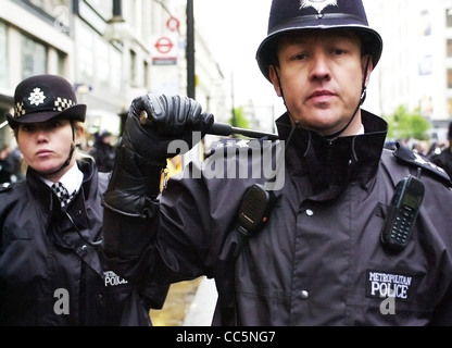 Street policeman with baton raised EDITORIAL USE ONLY British UK NO MODEL RELEASE - EDITORIAL USE ONLY Stock Photo