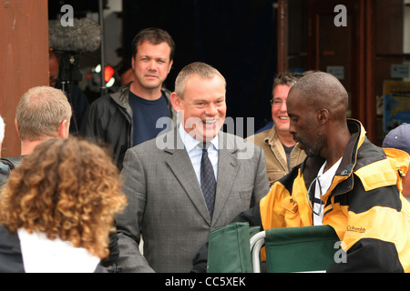 Actor Martin Clunes on the set of Doc Martin outside the lifeboat station in Port Isaac on the North Cornwall Coast. Stock Photo