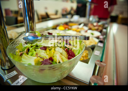 Buffet counter of salad cold meats fruits rice and pasta Stock Photo