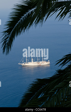 A boat sails along the Italian coast near the town of Amalfi Stock Photo