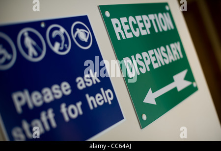 Reception and dispensary signage with please ask staff for details sign Stock Photo