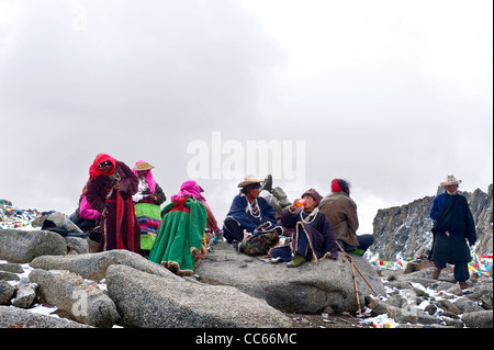 Tibetan people resting on a mountainside, Ngari, Tibet, China Stock Photo