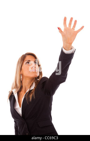 businesswoman trying to reach something with her hand Stock Photo