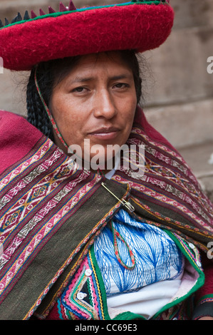 Peru, Chincheros. Peruvian woman in traditional dress at the local artisan coop workshop. Stock Photo