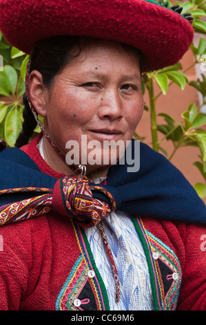 Peru, Chincheros. Peruvian woman in traditional dress at the local artisan coop workshop. Stock Photo