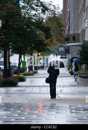 Man walking with umbrella Stock Photo - Alamy