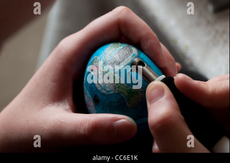 Hands etching a egg in Polish tradition of Pisanki  Stock Photo