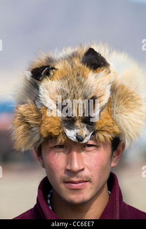 Portrait of a Kazakh man wearing a furry fox hat to his head. Stock Photo