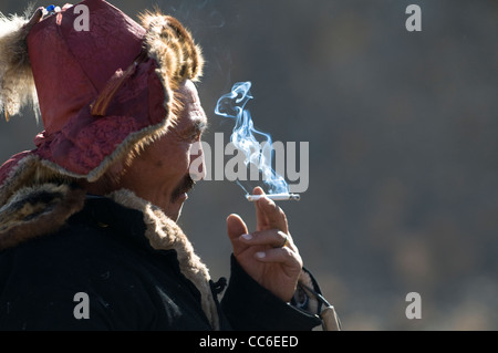 A Kazakh man enjoys a cigarette. Stock Photo