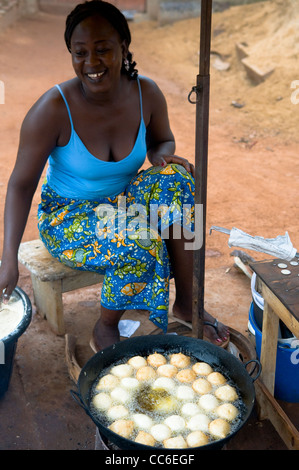 A Burkinabe woman deep frying gateaux ( fried doughnuts ). This is a popular breakfast in Burkina faso and west Africa. Stock Photo