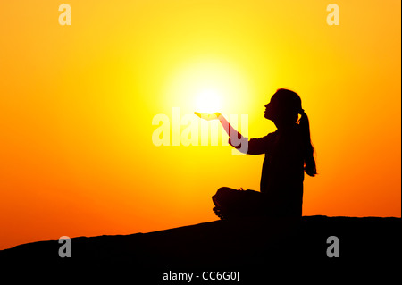 Indian girl holding the sun. Silhouette Stock Photo