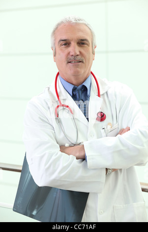 mature physician with folded arms Stock Photo