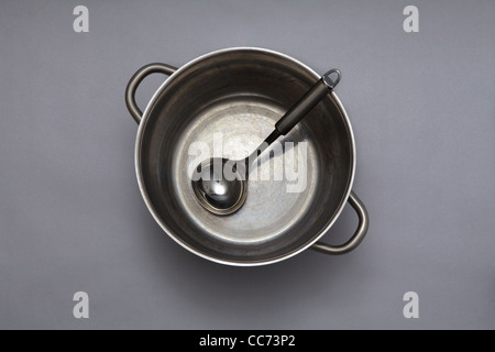 Large metal cooking pot with spoon Stock Photo